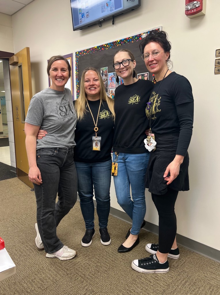 Four women with Sycamore Education Association t-shirts on.